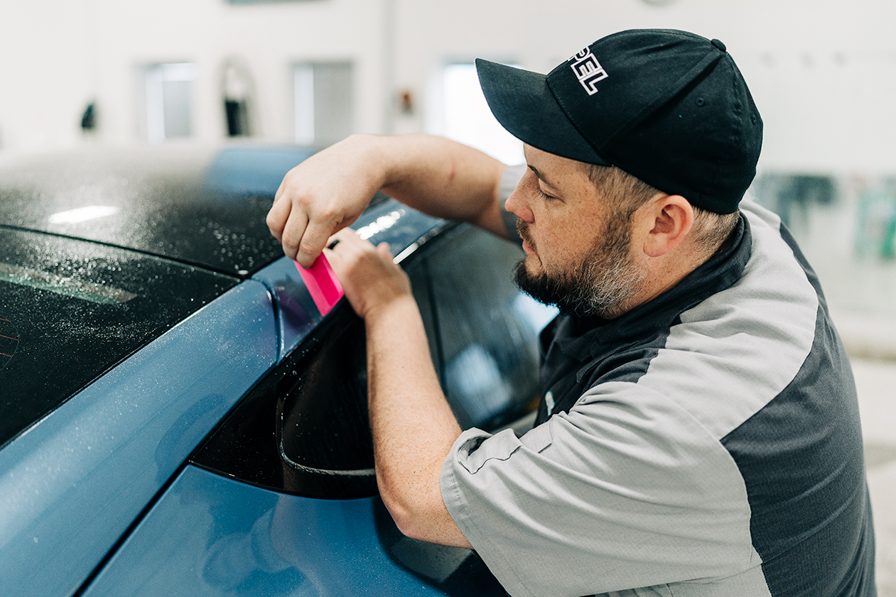 Installer in Cincinnati Ohio applying Xpel Paint Proction Film